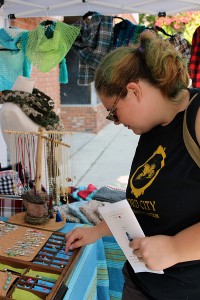 Jessie Jakos through Handmade by Deb's jewelry display at the festival. (Photo by Vanessa Cuevas)