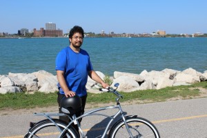 Oran Amato stands with his bicycle on Riverside Drive. (Photo by Barry Hazlehurst)