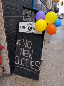A sign outside of the entrance to Full Circle Vintage on University Avenue West declaring #NoNewClothes. Photo by Alyssa Leonard