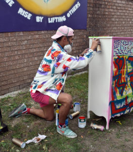 Eugenio Mendoza, locally known as DREVMZ, paints a dresser at the second annual Dropped on Drouillard event on Saturday, Sept 22, 2018. Mendoza created 12 pieces of art in 12 hours. Photo by Alyssa Leonard